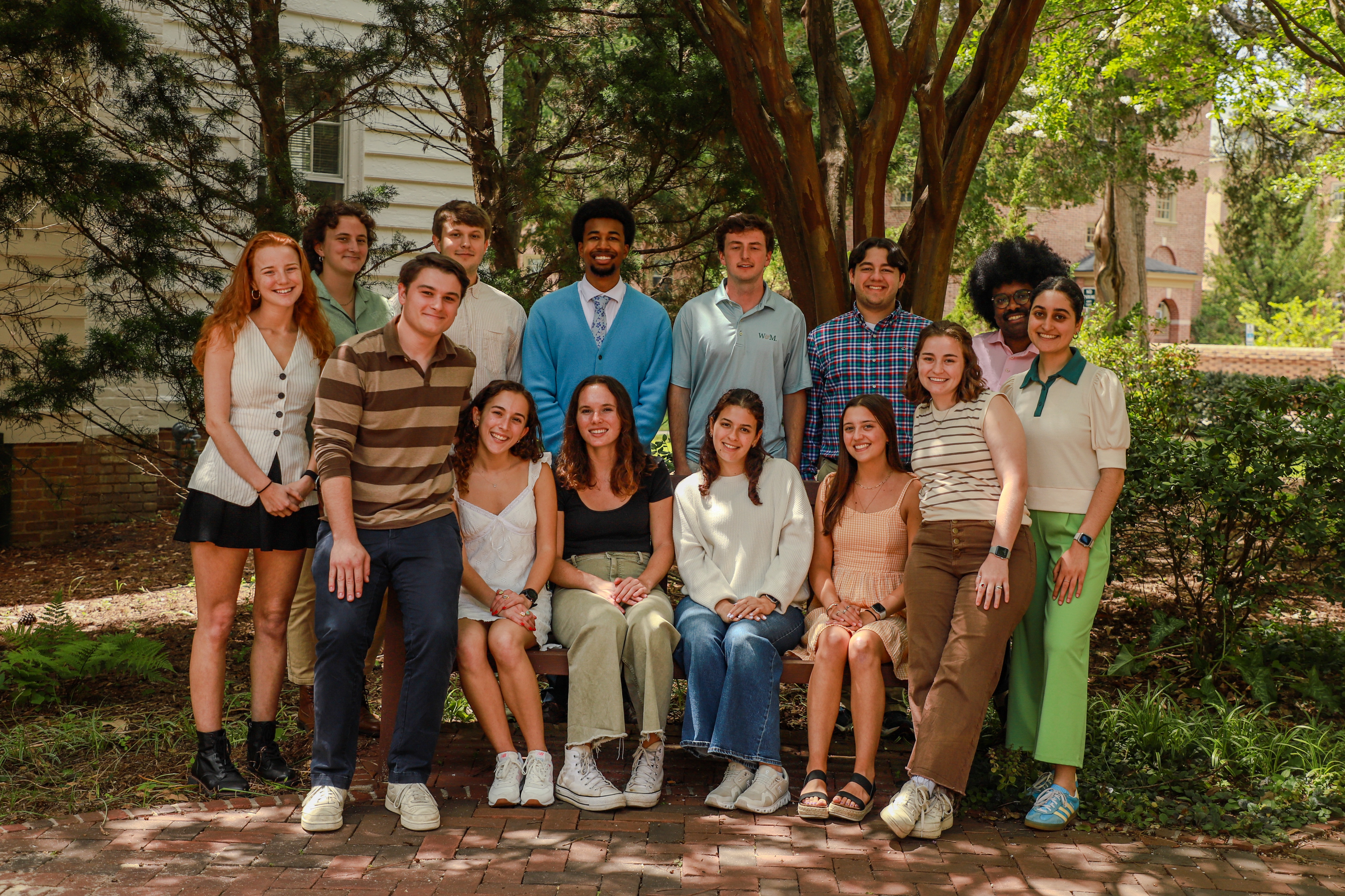 The group of interviewers smiling together in the courtyard next to undergraduate admission