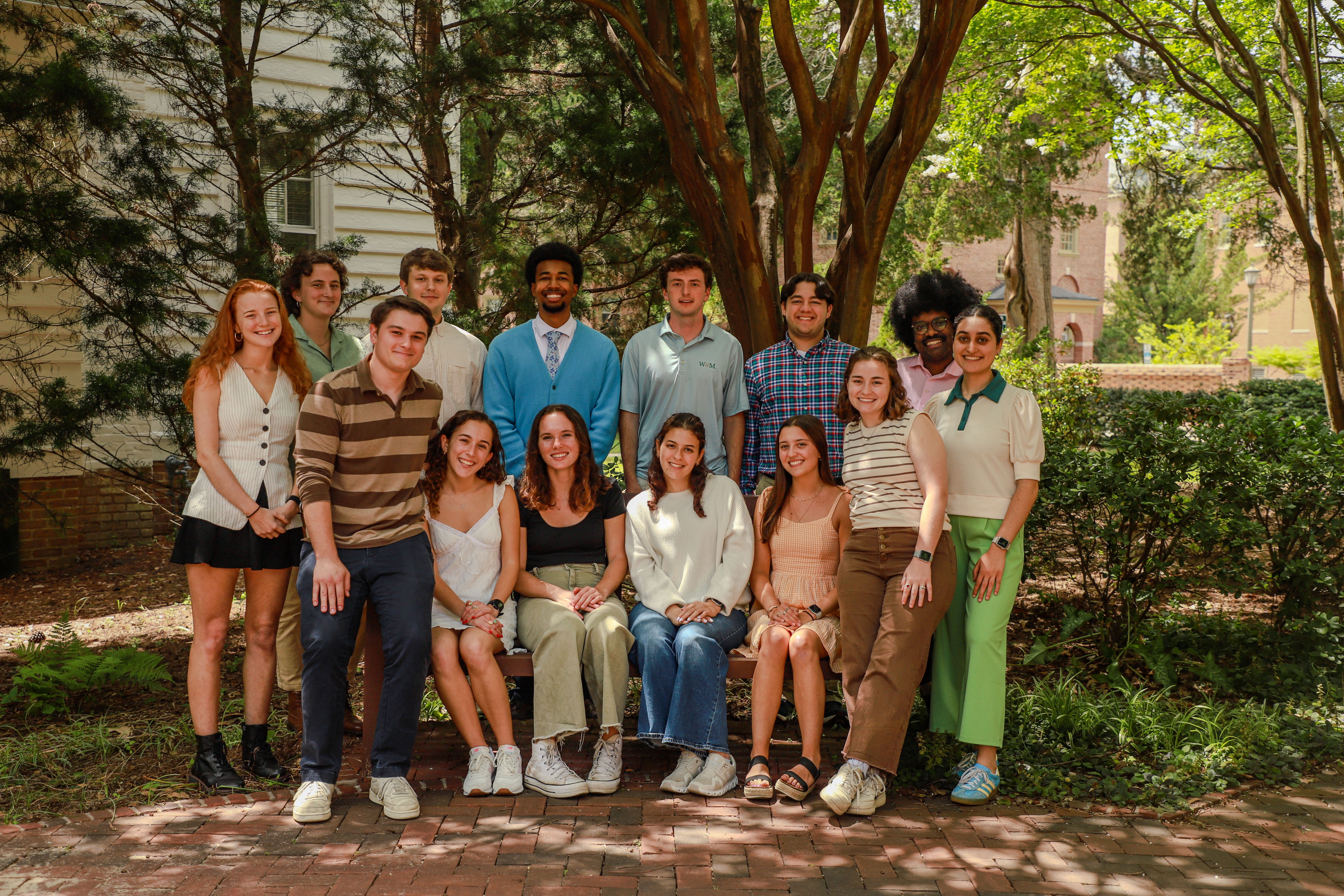 The group of interviewers smiling together in the courtyard next to undergraduate admission