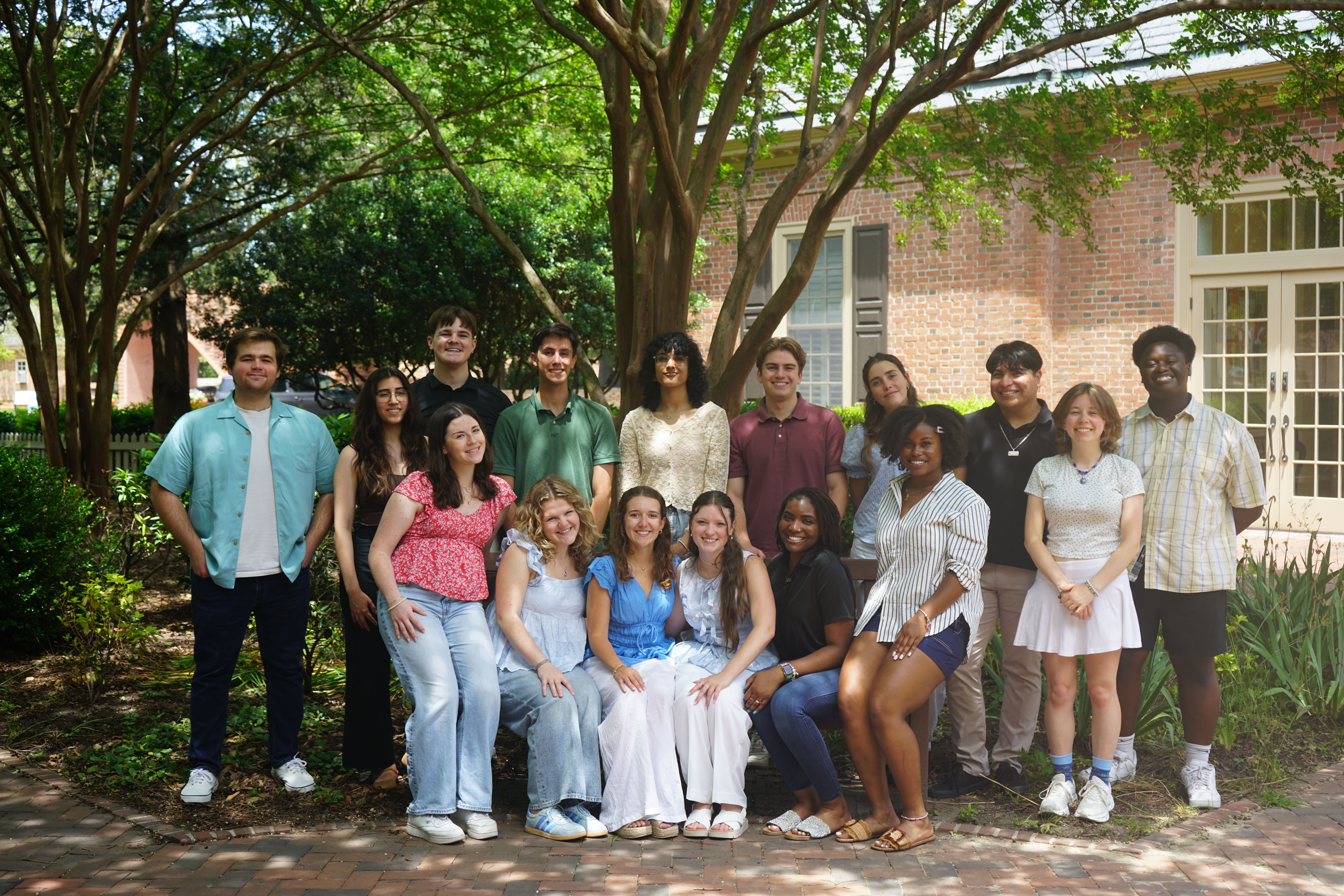 The group of interviewers smiling together in the courtyard next to undergraduate admission